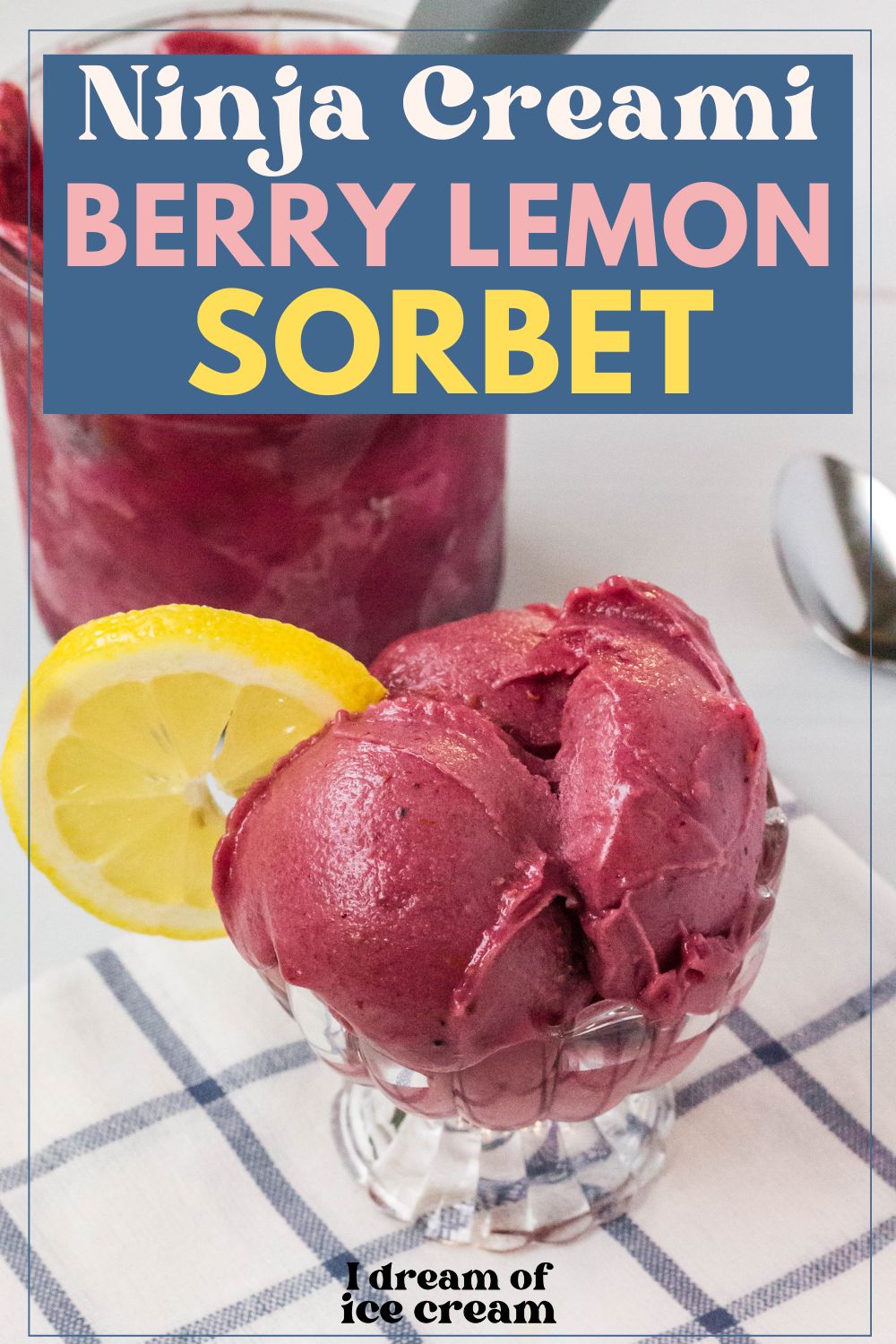 a glass dish with three scoops of Ninja Creami berry lemonade sorbet in it, garnished with a lemon slice. The remaining pint is in the background.