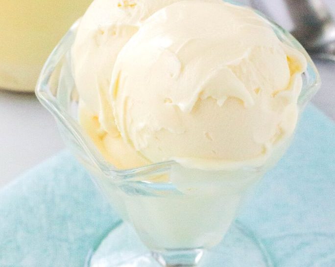 close-up of two scoops of ninja creami vanilla pudding ice cream served in a glass ice cream dish