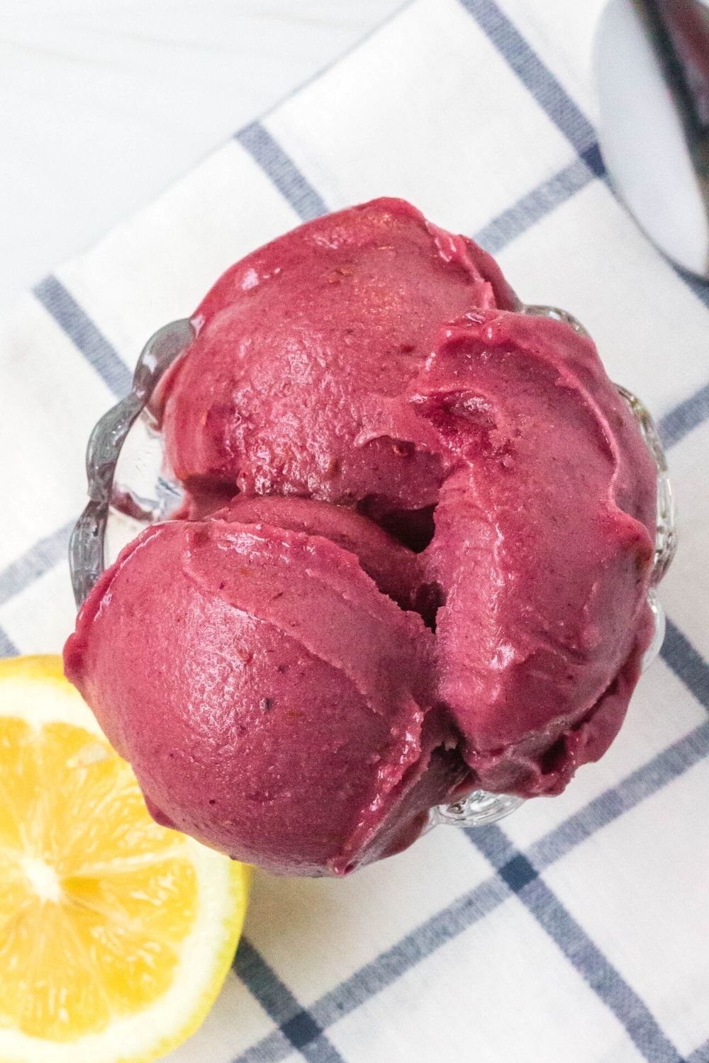 overhead view of three scoops of berry lemon sorbet that was made in the ninja creami, served in a glass dish.