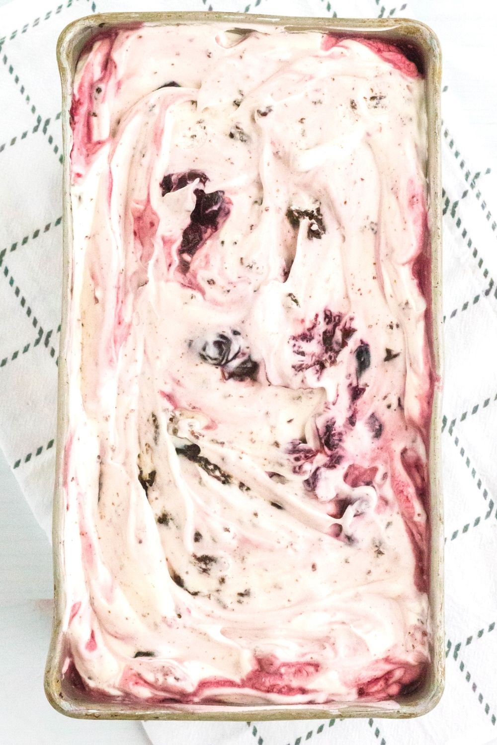 overhead view of a loaf pan filled with homemade no-churn black forest ice cream, frozen and ready to serve