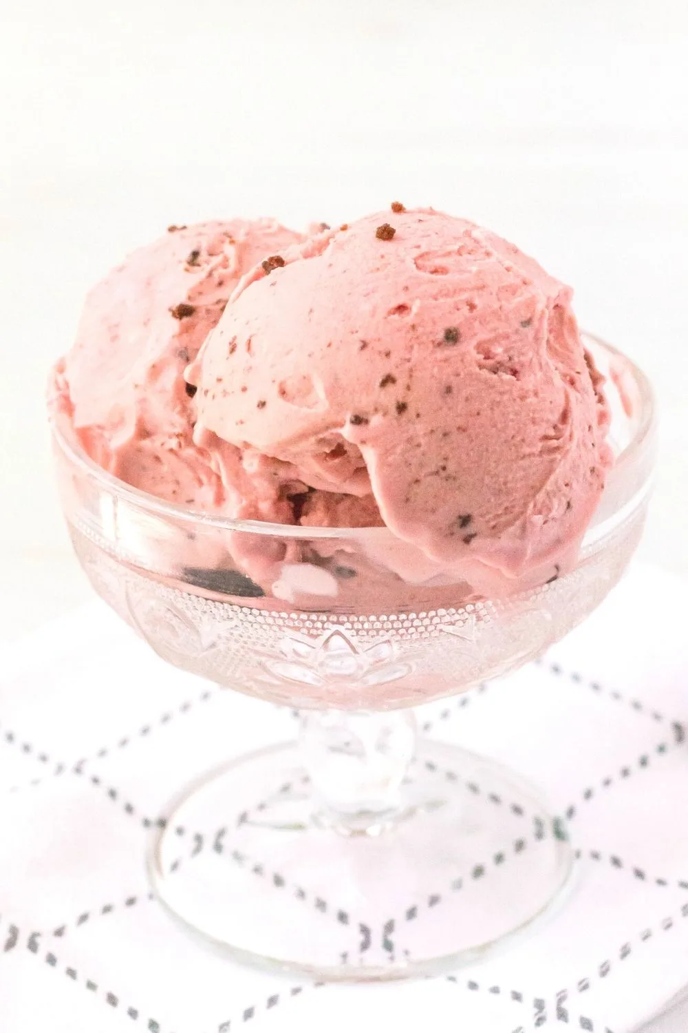 side view of a glass dish filled with scoops of Ninja Creami cherry chocolate chip ice cream