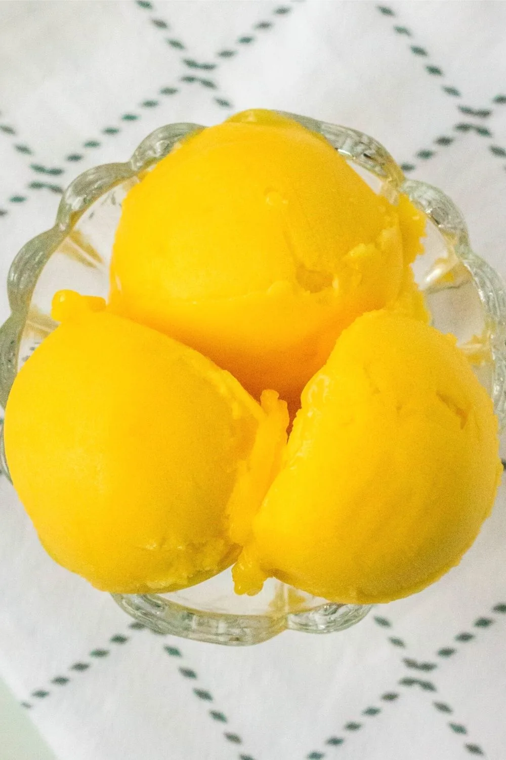 easy mango sorbet made in the ninja creami is served from a glass dish