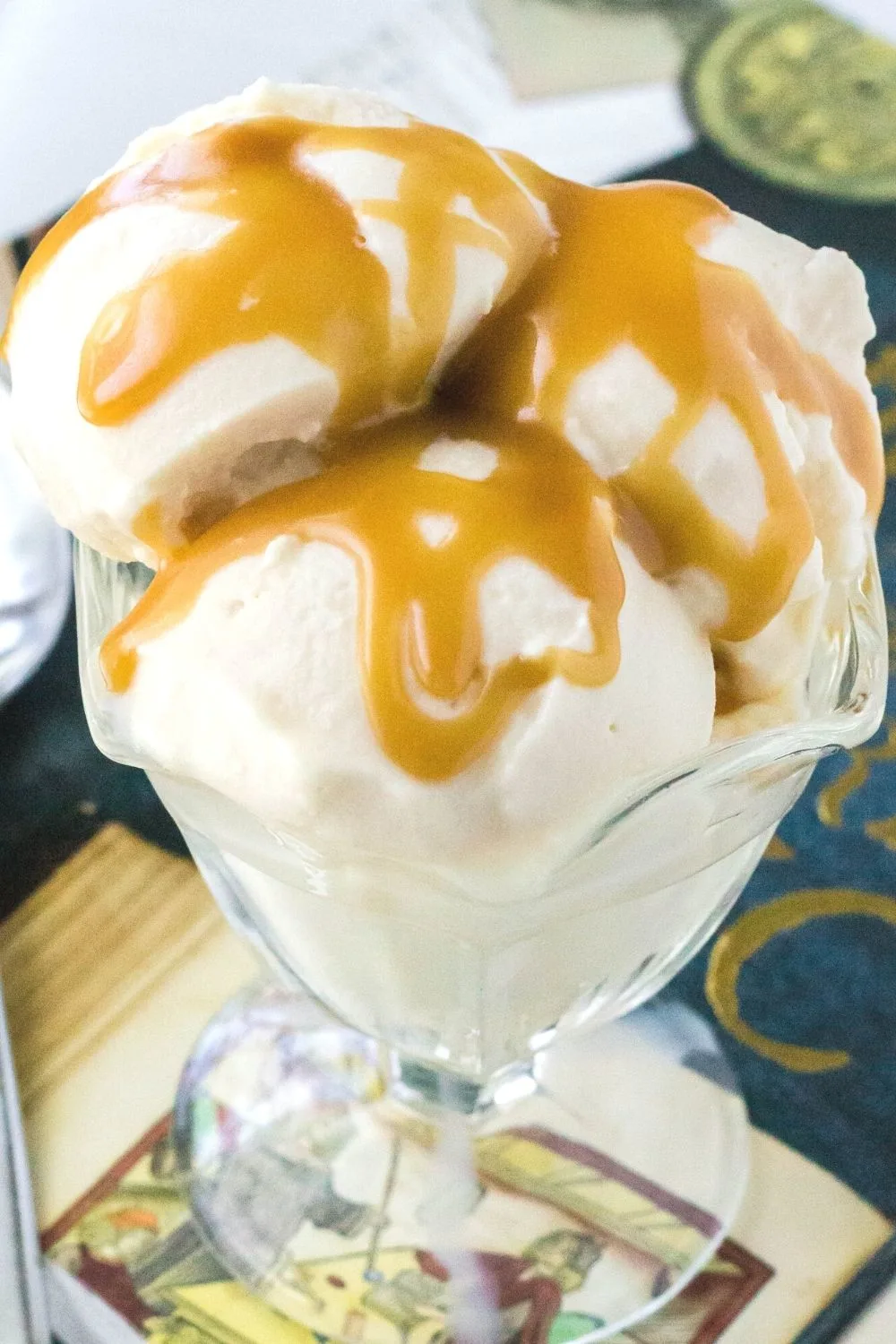 close-up side view of a serving of Ninja Creami butterbeer ice cream topped with a drizzle of homemade butterscotch sauce