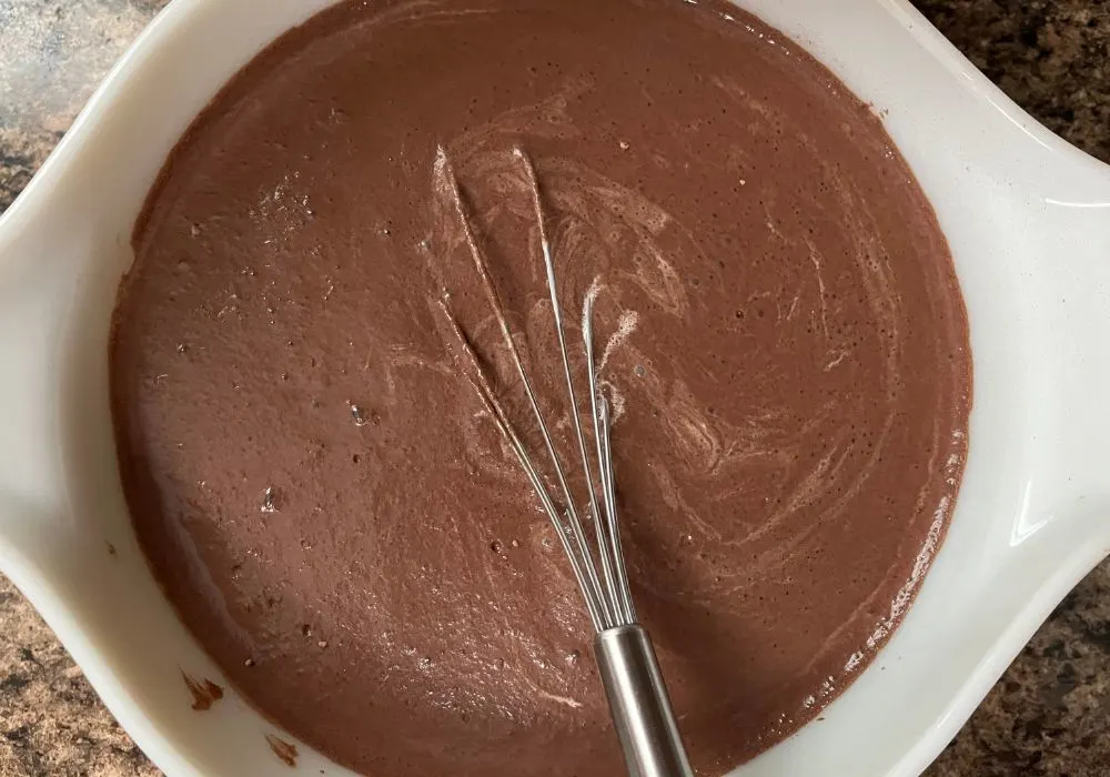 heavy cream and vanilla added to the milk mixture, whisked together to create the base for the chocolate ice cream.