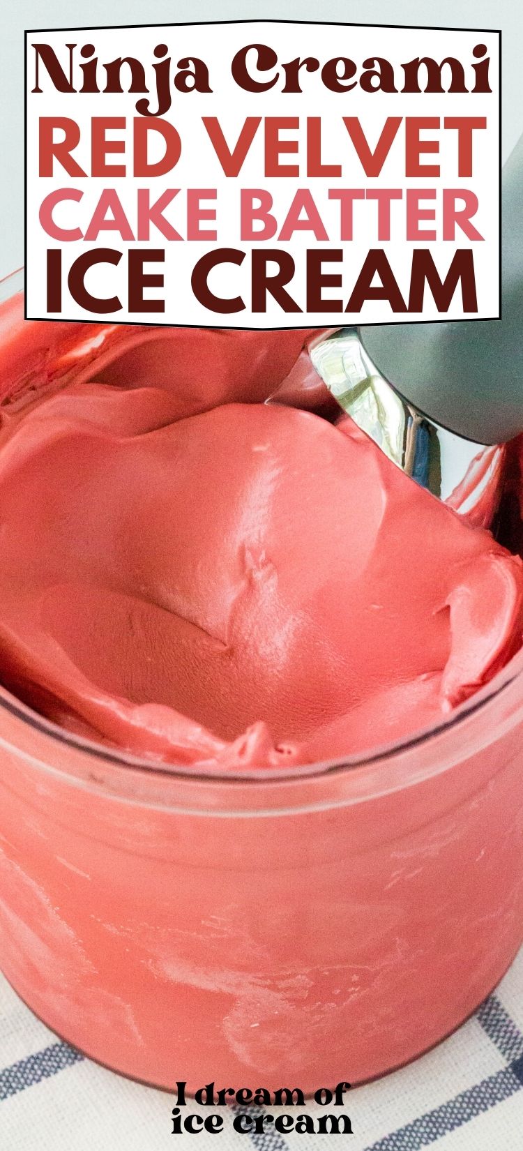 close-up view of the top surface of a pint of ninja creami red velvet cake batter ice cream with a scoop in it