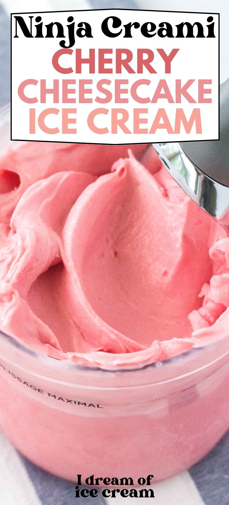 an ice cream scoop swirls the surface of cherry cheesecake ice cream in a Ninja Creami pint container. An overlay reads, "Ninja Creami cherry cheesecake ice cream"
