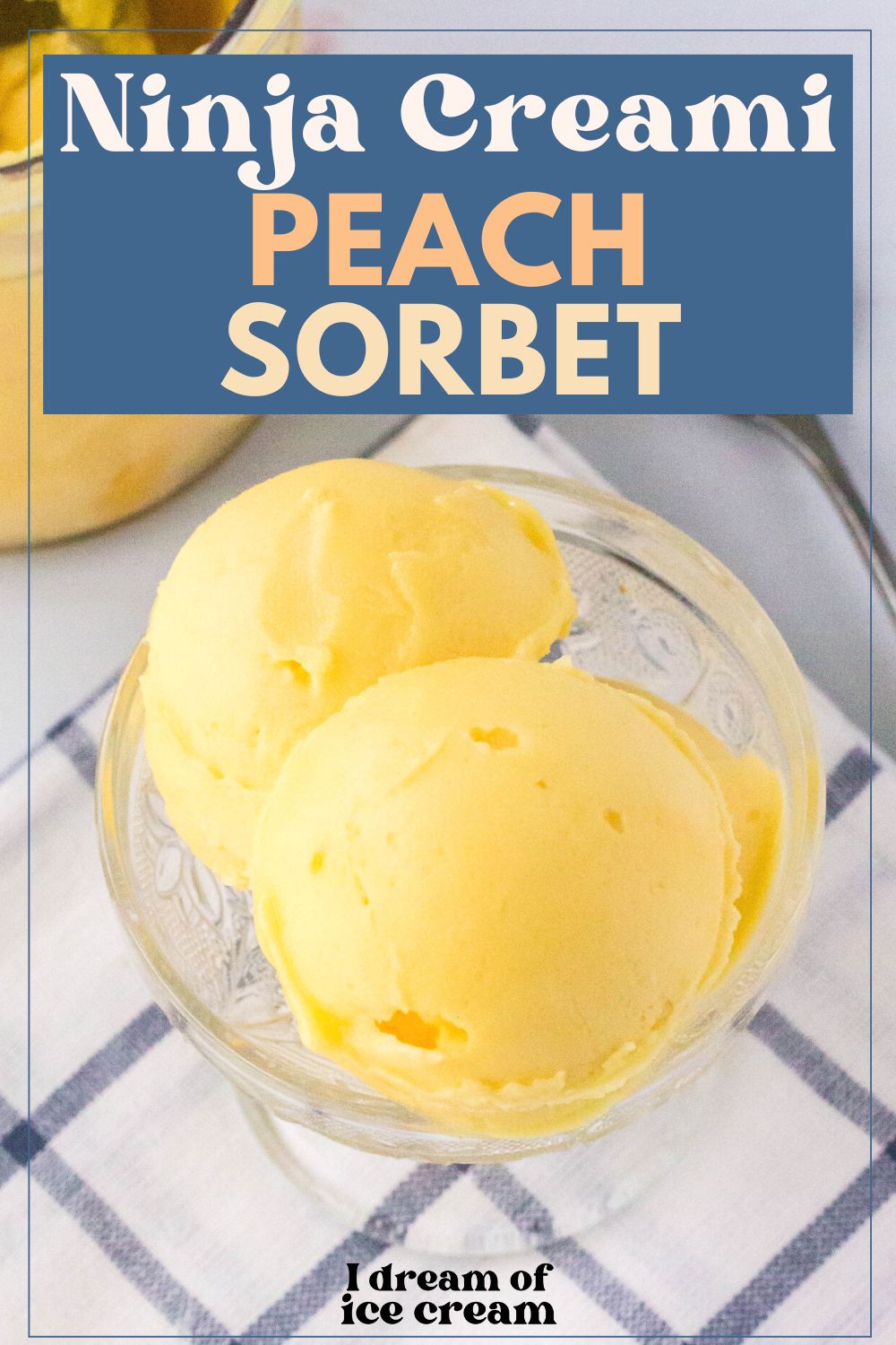 two scoops of Ninja Creami peach sorbet served in a glass dish atop a blue and white napkin.
