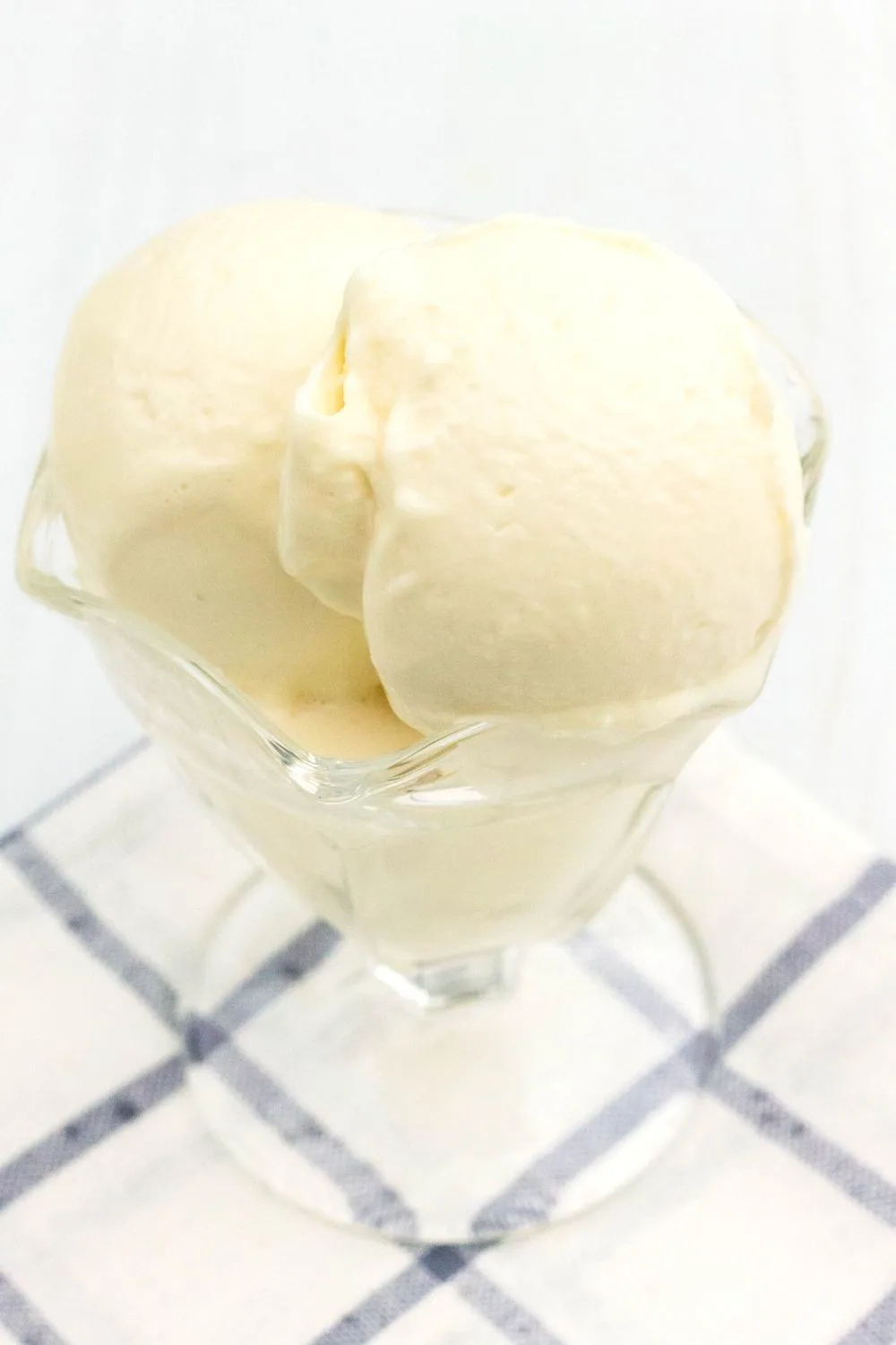 close-up view of two scoops of cottage cheese ice cream in a glass ice cream cup