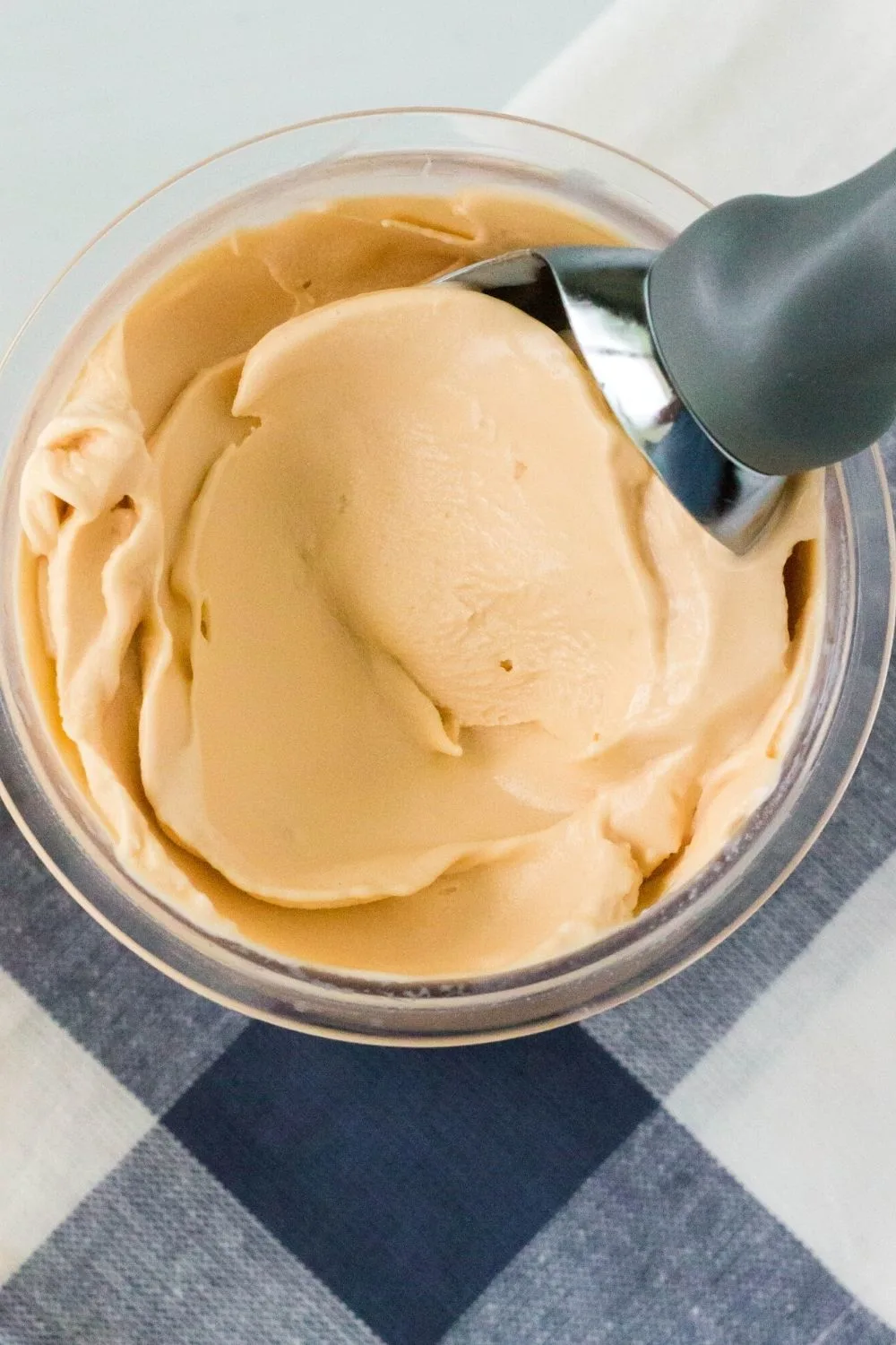 overhead view of a pint container of homemade butterscotch pudding ice cream made in the Ninja Creami machine.