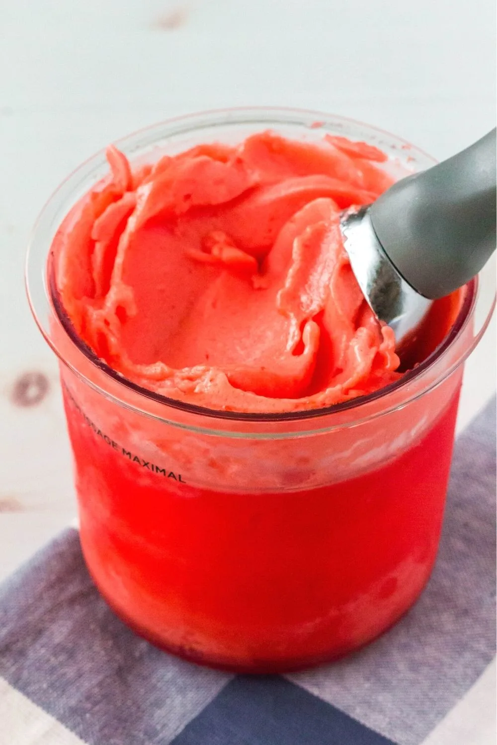 ninja creami strawberry sorbet made from gelatin, with an ice cream scoop in the sorbet