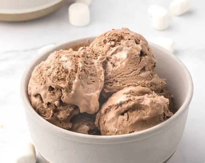 a white bowl serves scoops of chocolate marshmallow ice cream