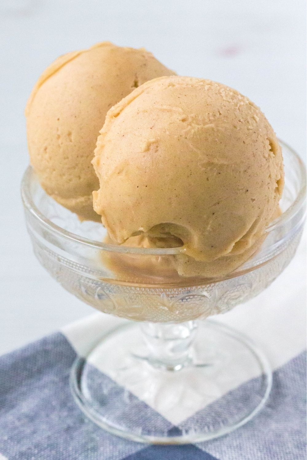 close-up side view of scoops of Ninja Creami applesauce sorbet in a glass dish