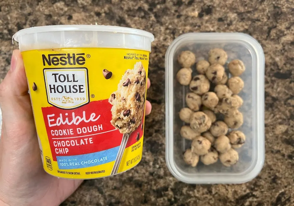 A container of Nestle Toll House edible cookie dough next to a dish of small rolled bites of cookie dough.