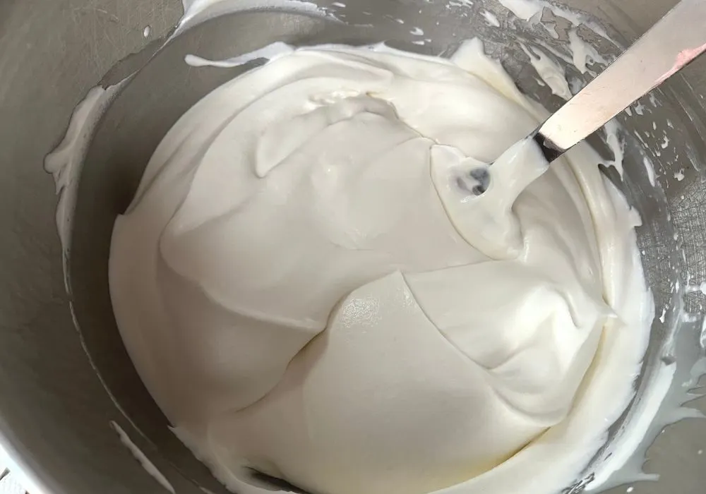 sweetened condensed milk and vanilla extract folded into whipped cream with a rubber spatula.