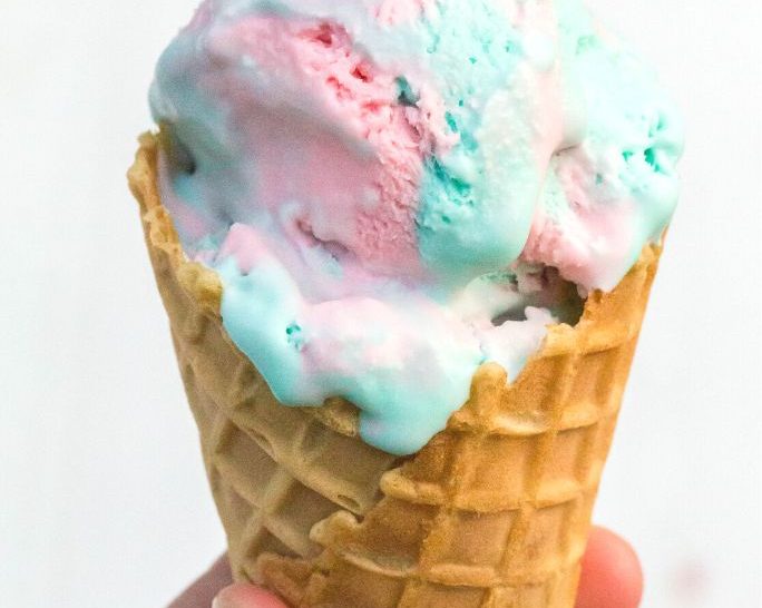 scoop of no churn cotton candy ice cream served in a waffle cone