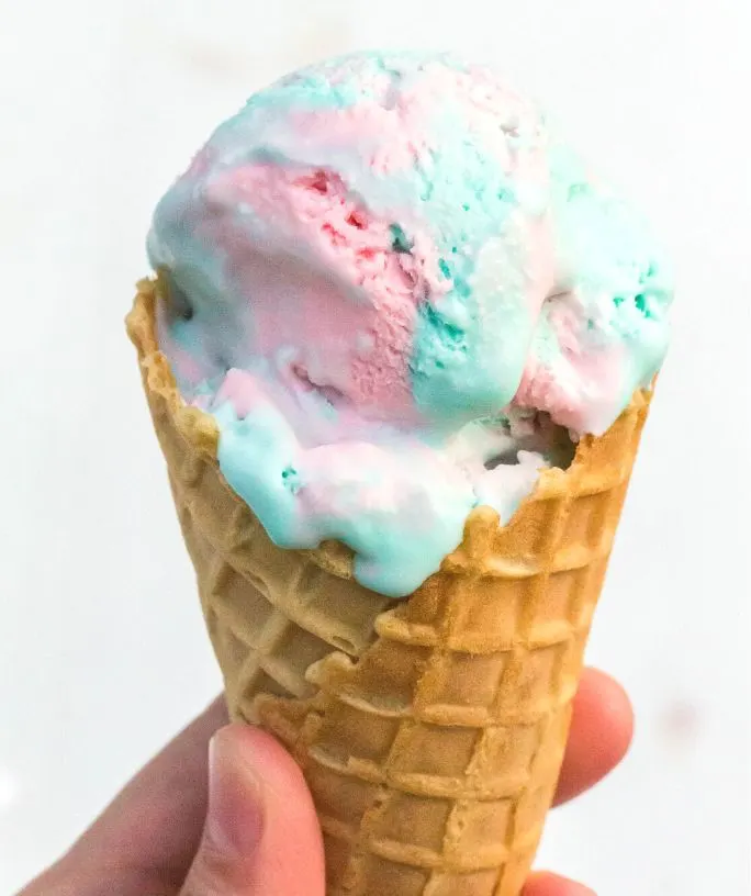 scoop of no churn cotton candy ice cream served in a waffle cone