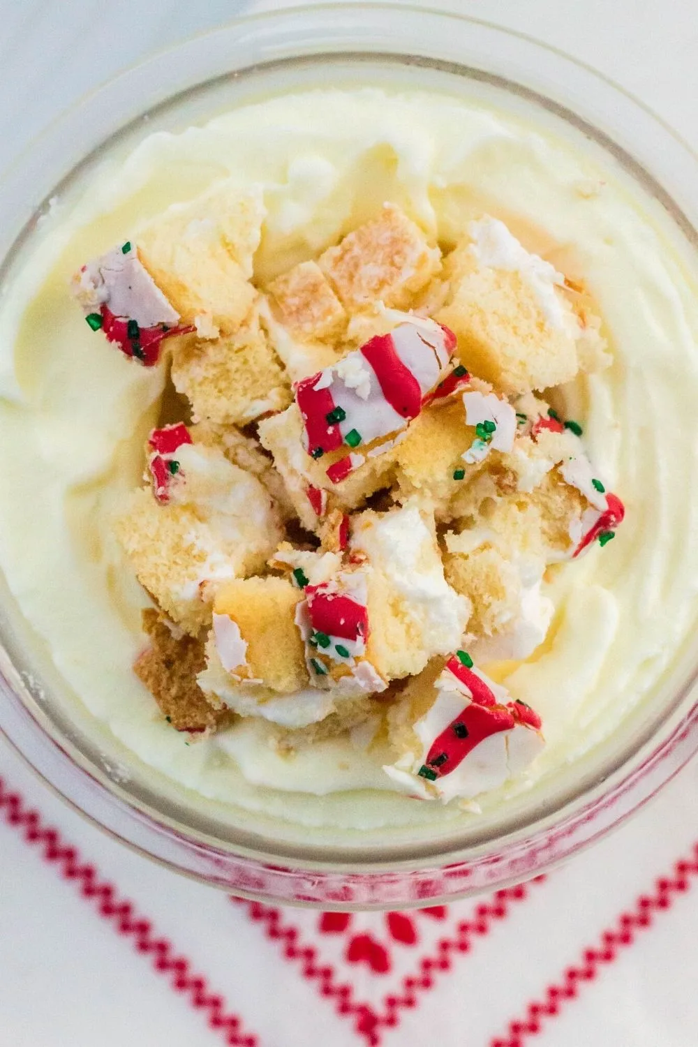 close-up overhead view of a pint of Ninja Creami ice cream topped with Christmas Tree Cake pieces