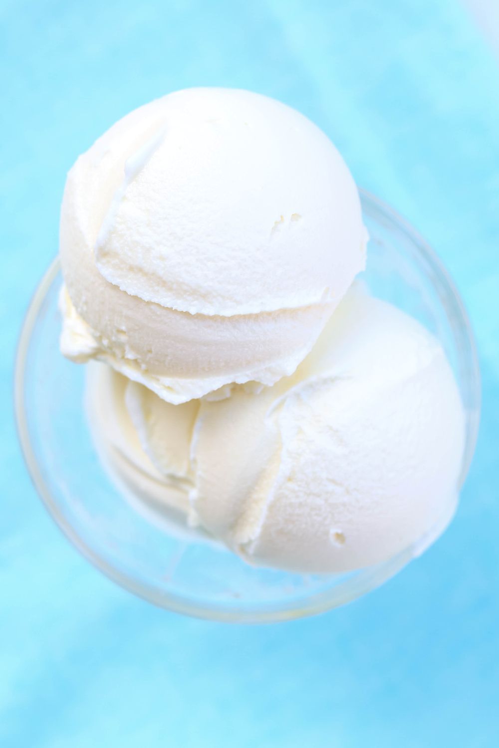 close-up view of scoops of silky smooth Ninja Creami vanilla ice cream made with Cool Whip, served in a glass dish.