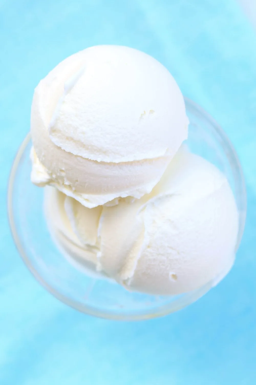 close-up view of scoops of silky smooth Ninja Creami vanilla ice cream made with Cool Whip, served in a glass dish.