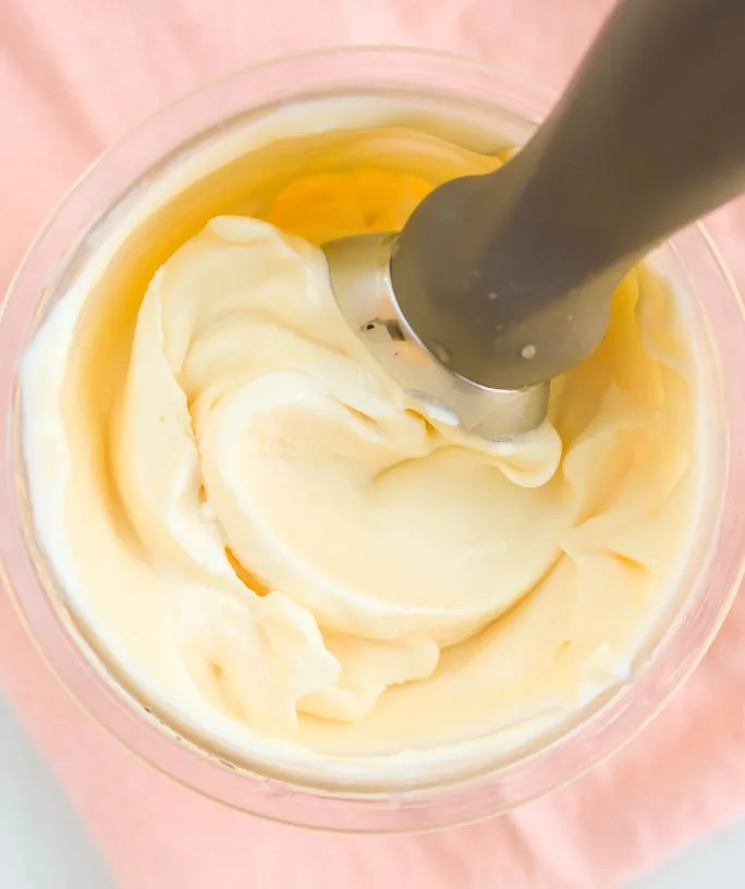 overhead view of Ninja Creami sweet cream ice cream in a pint container with an ice cream scoop