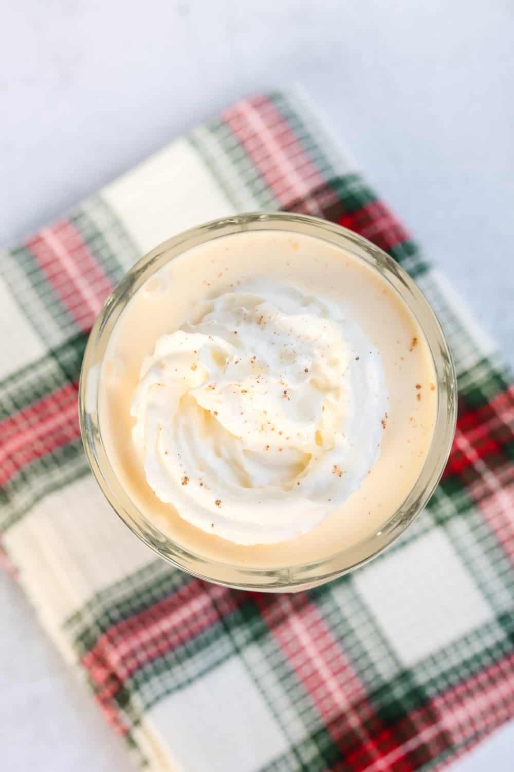 overhead view of a glass serving eggnog milkshake made in the Ninja Slushi machine.