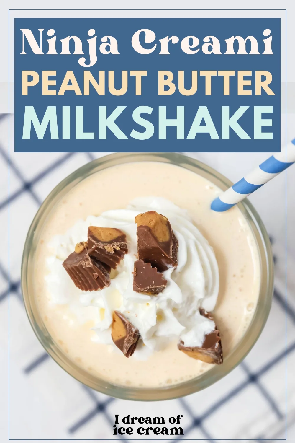 overhead view of a glass serving a Ninja Creami peanut butter milkshake, topped with whipped cream and chopped peanut butter cups.