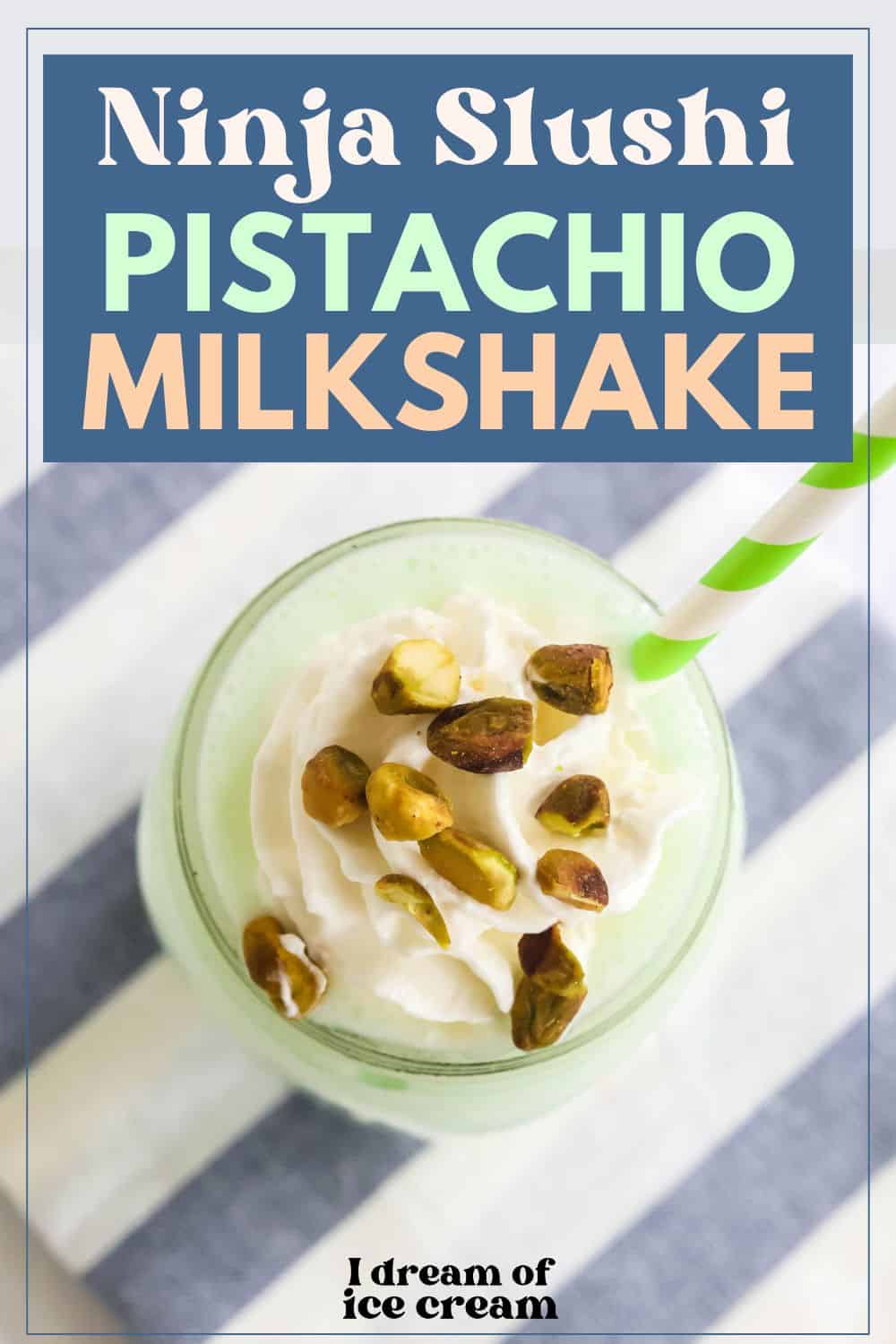 overhead view of a glass of Ninja Slushi pistachio milkshake, topped with whipped cream and chopped pistachios. A green and white striped straw is in the milkshake.