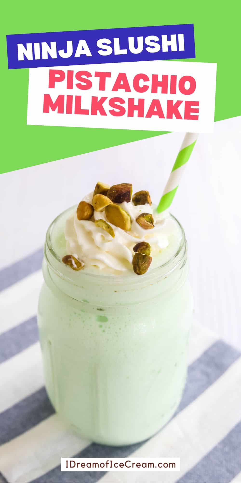 a mason jar glass containing Ninja Slushi pistachio milkshake, garnished with whipped cream and nuts.