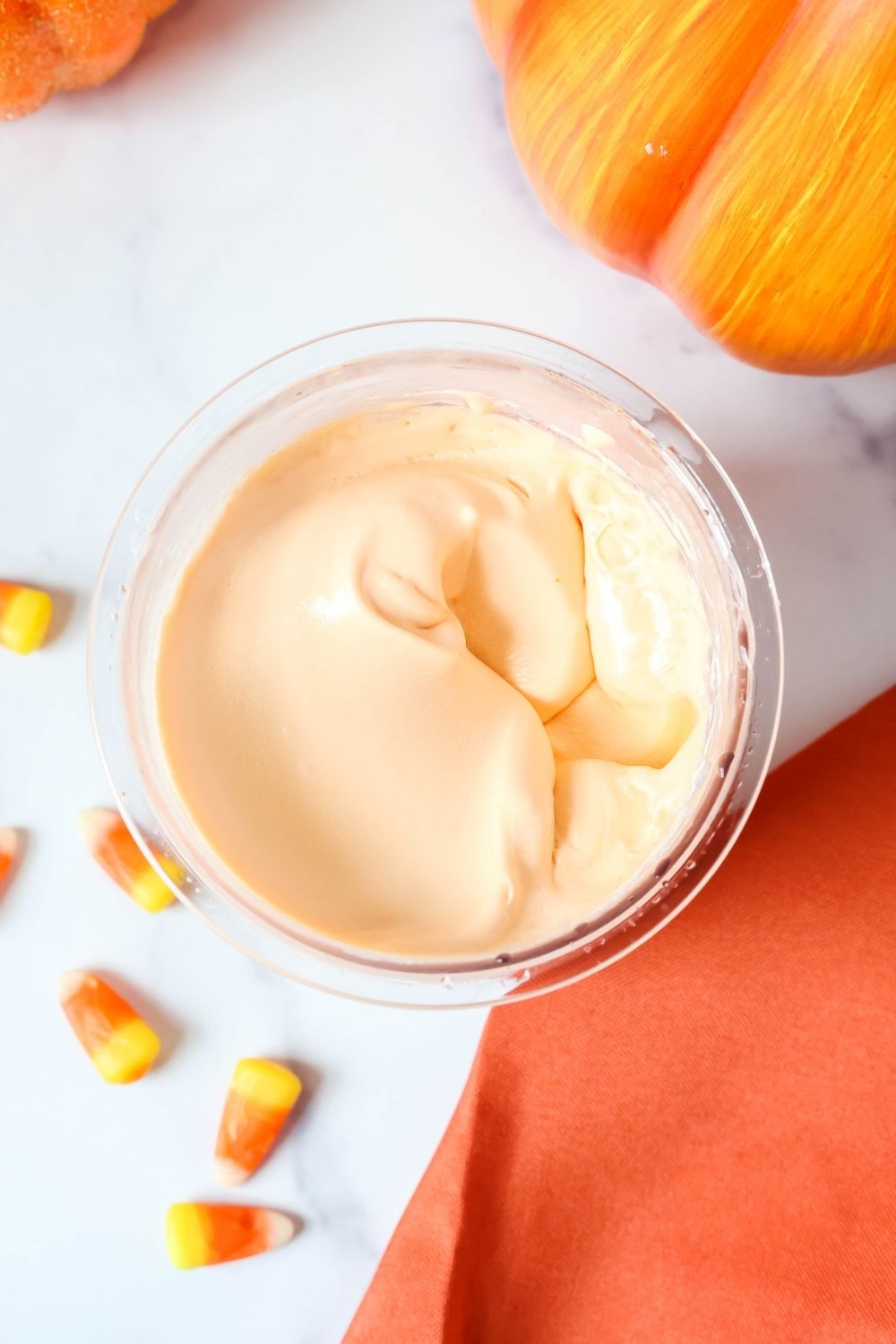 overhead view of a pint of Ninja Creami candy corn flavored ice cream, showing its smooth and creamy texture.