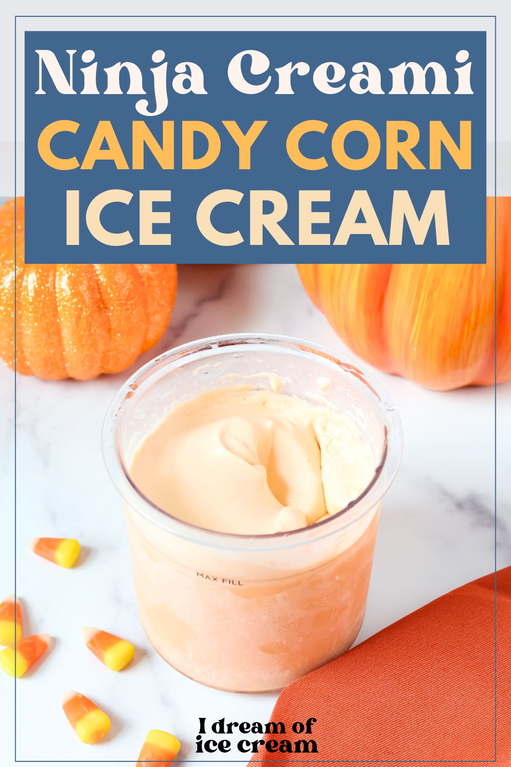 pint of Ninja Creami candy corn ice cream, with candy corns and decorative pumpkins scattered around.