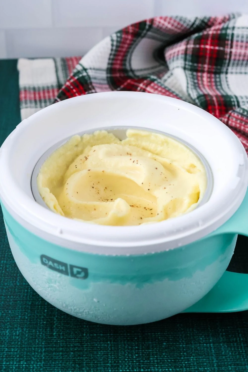 Dash Mug ice cream maker bowl with eggnog ice cream in it.