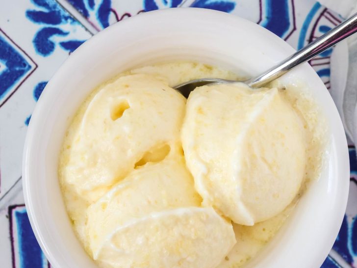 fresh pineapple sorbet served in a white bowl with a spoon.