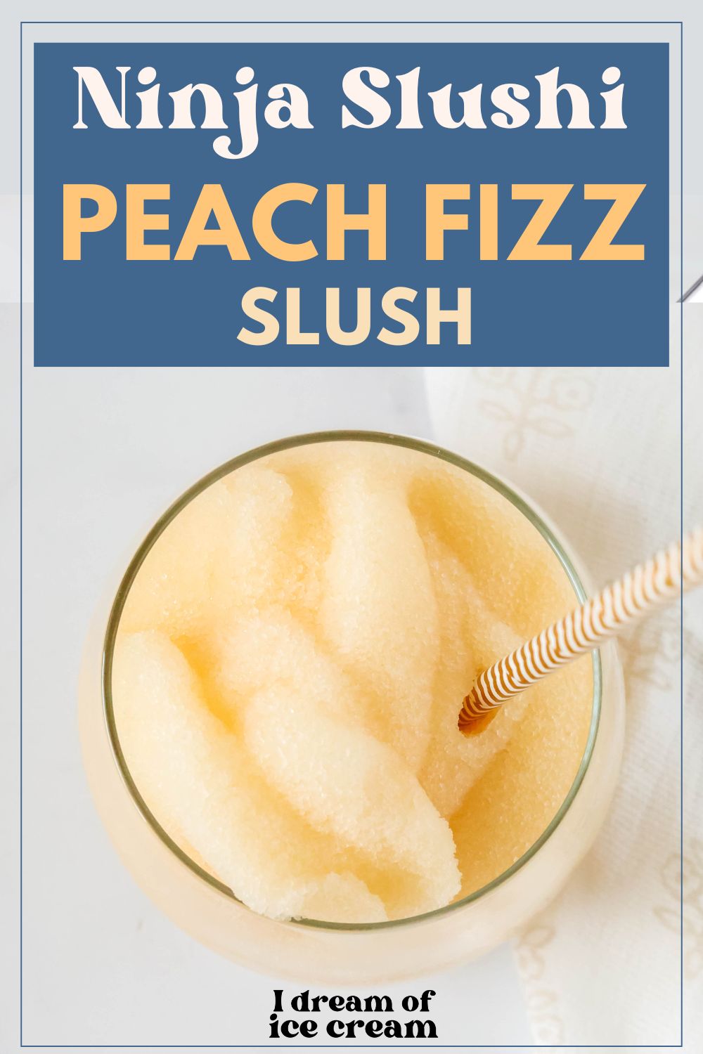 overhead view of a glass of Ninja Slushi peach slush with a straw in it.
