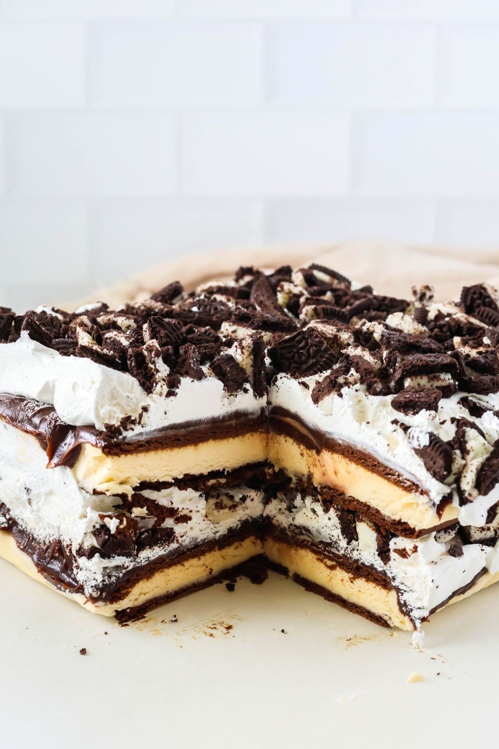 Ice cream sandwich dessert with a slice cut out of it.