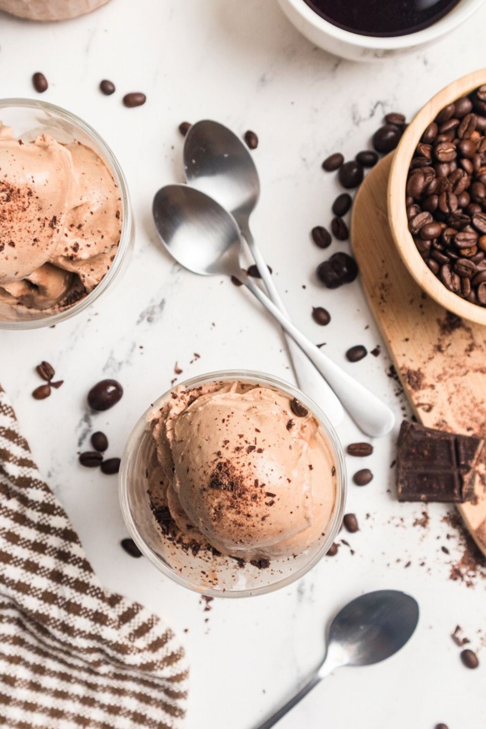 overhead view of glass dessert cups filled with scoops of Ninja Creami mocha coffee ice cream made with espresso. Spoons are next to the cups.