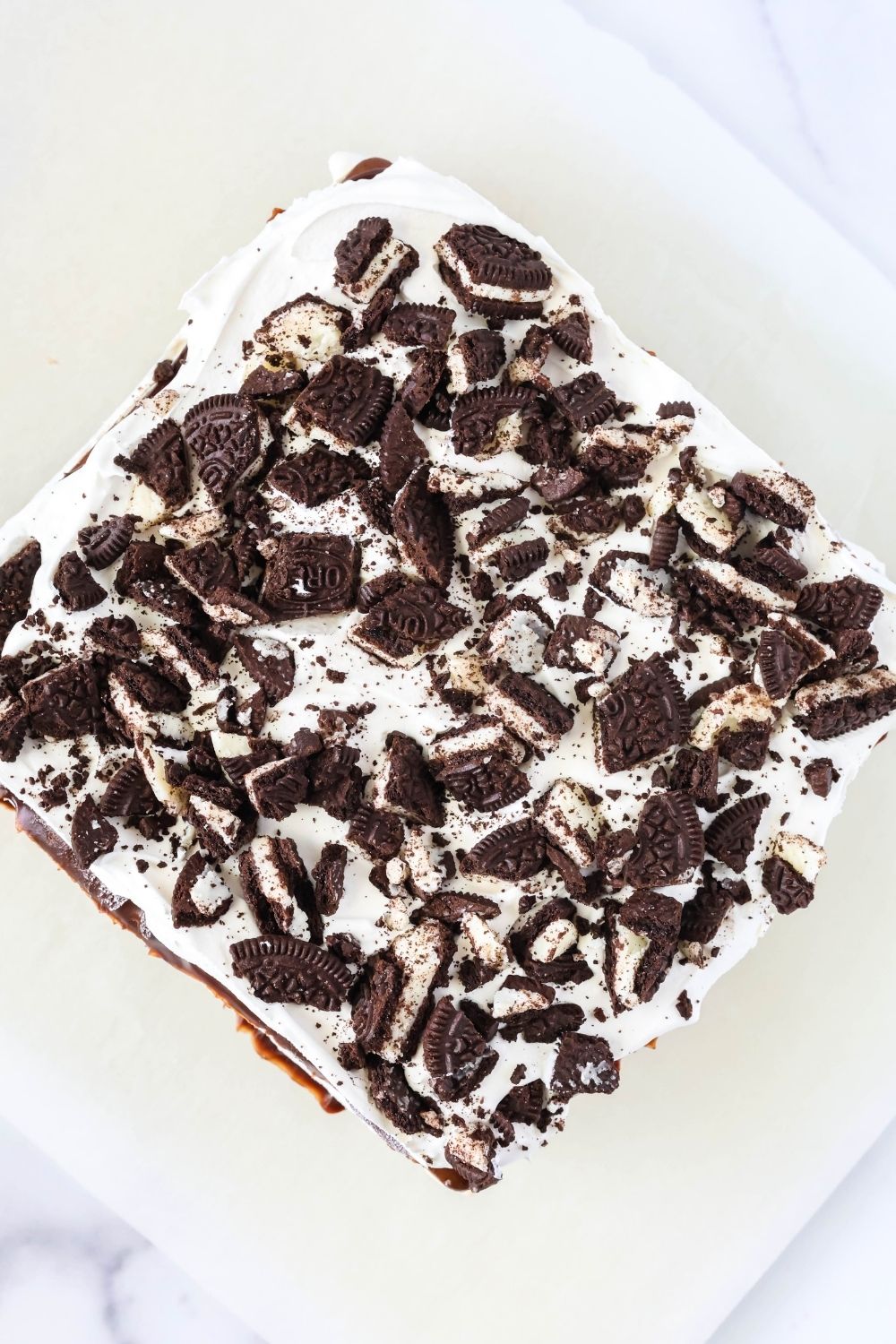 Overhead view of an Oreo ice cream sandwich cake on a serving plate